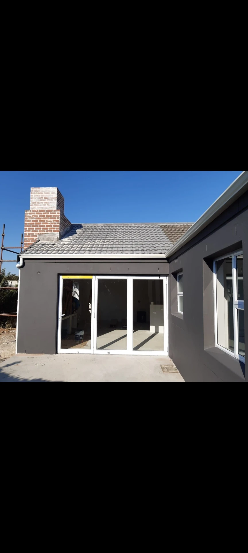 New extension with aluminium stacker doors and plastered walls